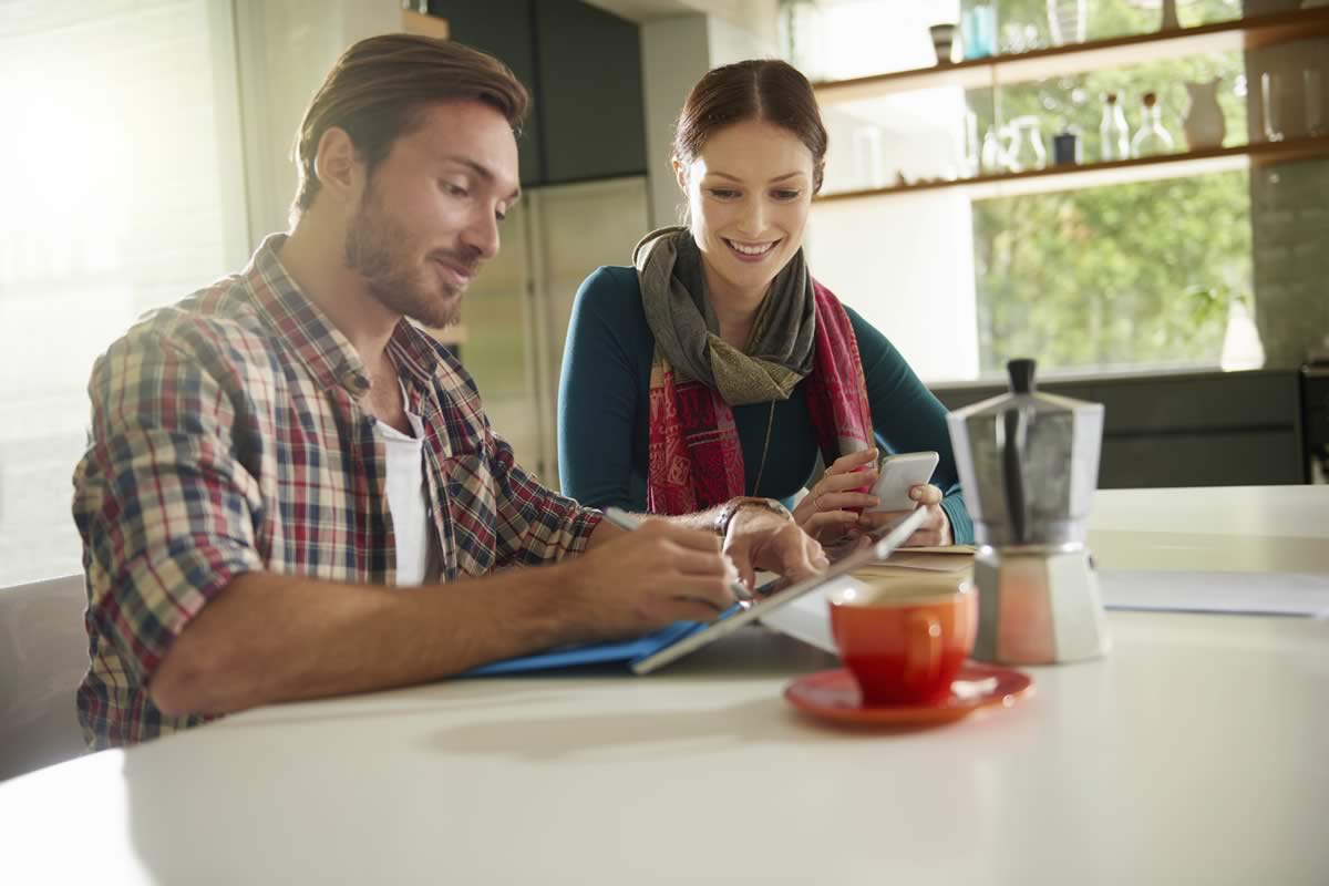 Two people having a discussion over coffee.